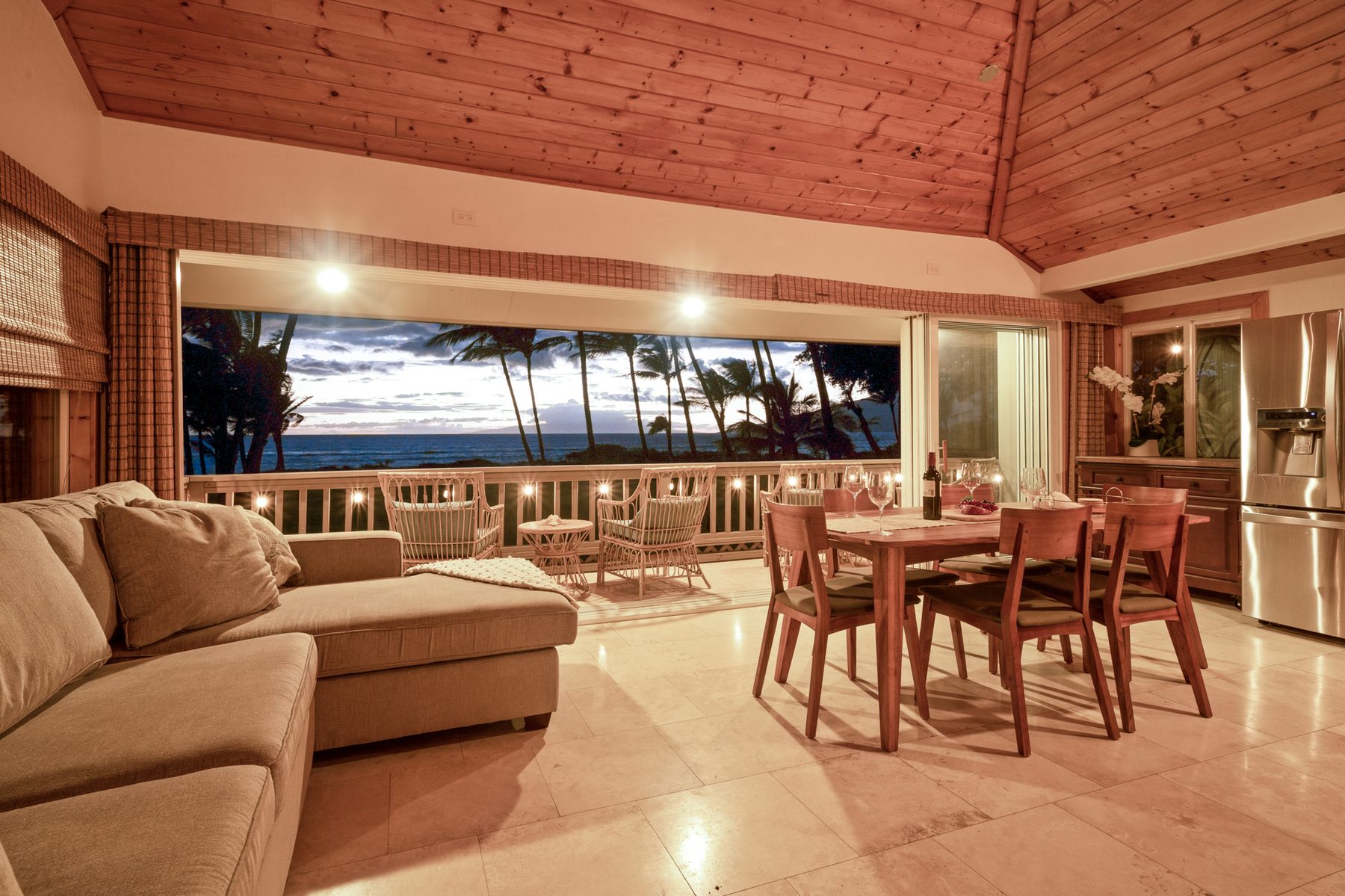 Living and dining at candlelit sunset with ocean view
